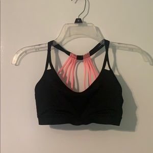 black and pink strappy sports bra